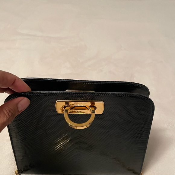 Authentic Salvatore Ferragamo black leather bag with shiny gold metal handle. - Picture 9 of 11